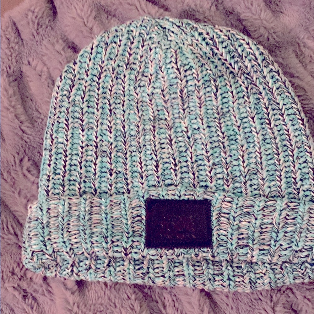 Love Your Melon Knit Beanie in Teal, White with black leather patch.